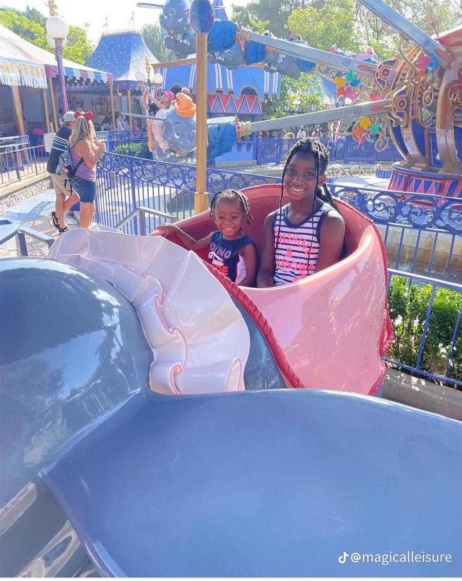 Two children riding Dumbo at Walt Disney World.